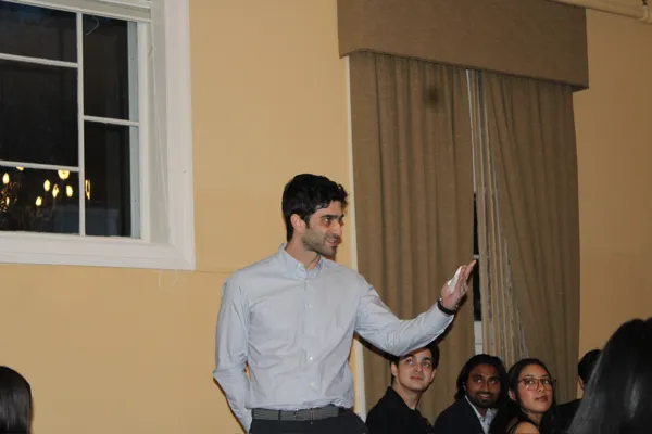 <br />
Board Member Ben Barasch ’14 gives new delegation some Aurelian history and alumni perspective during Initiation Dinner.